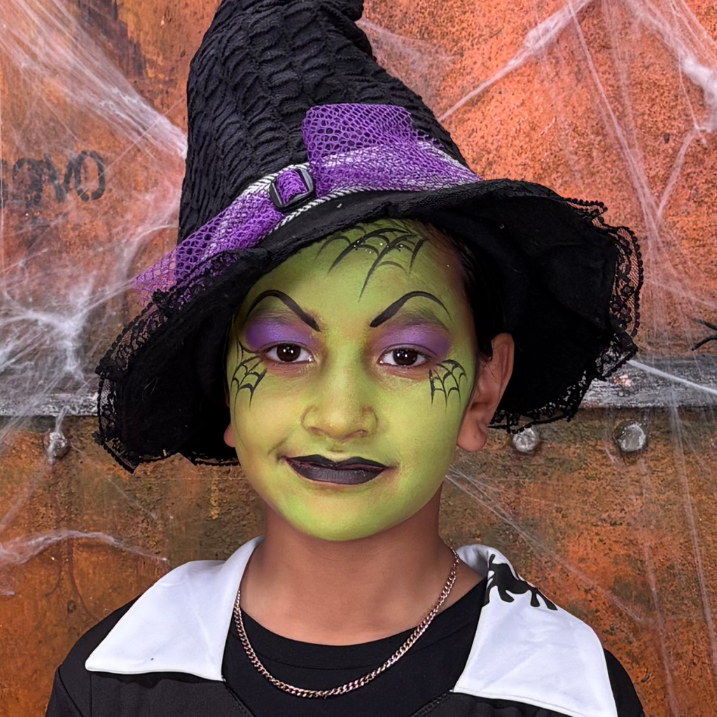 Child wearing a skeleton skull face paint design from the Halloween kit