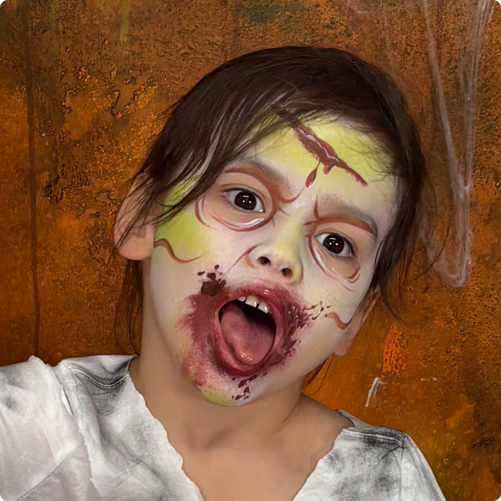 Child wearing a witch face paint design created with the Halloween kit