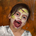 Child wearing a witch face paint design created with the Halloween kit