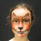 Child wearing a spider web face paint design from the Halloween kit