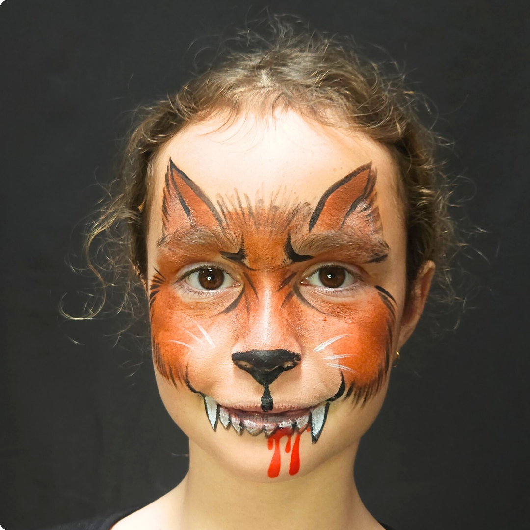 Child wearing a spider web face paint design from the Halloween kit