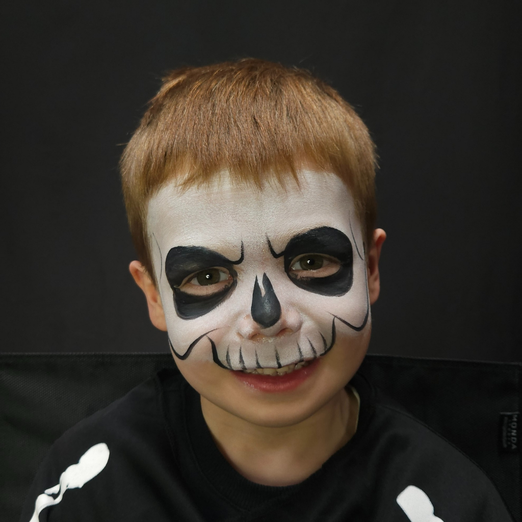 Child wearing a zombie face paint design made with the Halloween kit