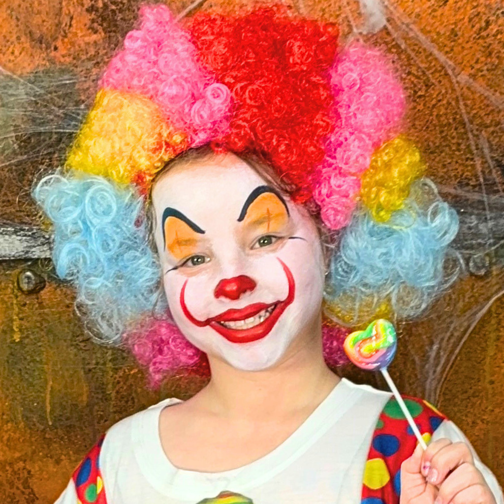 Child wearing a pumpkin face paint design made with the Halloween kit