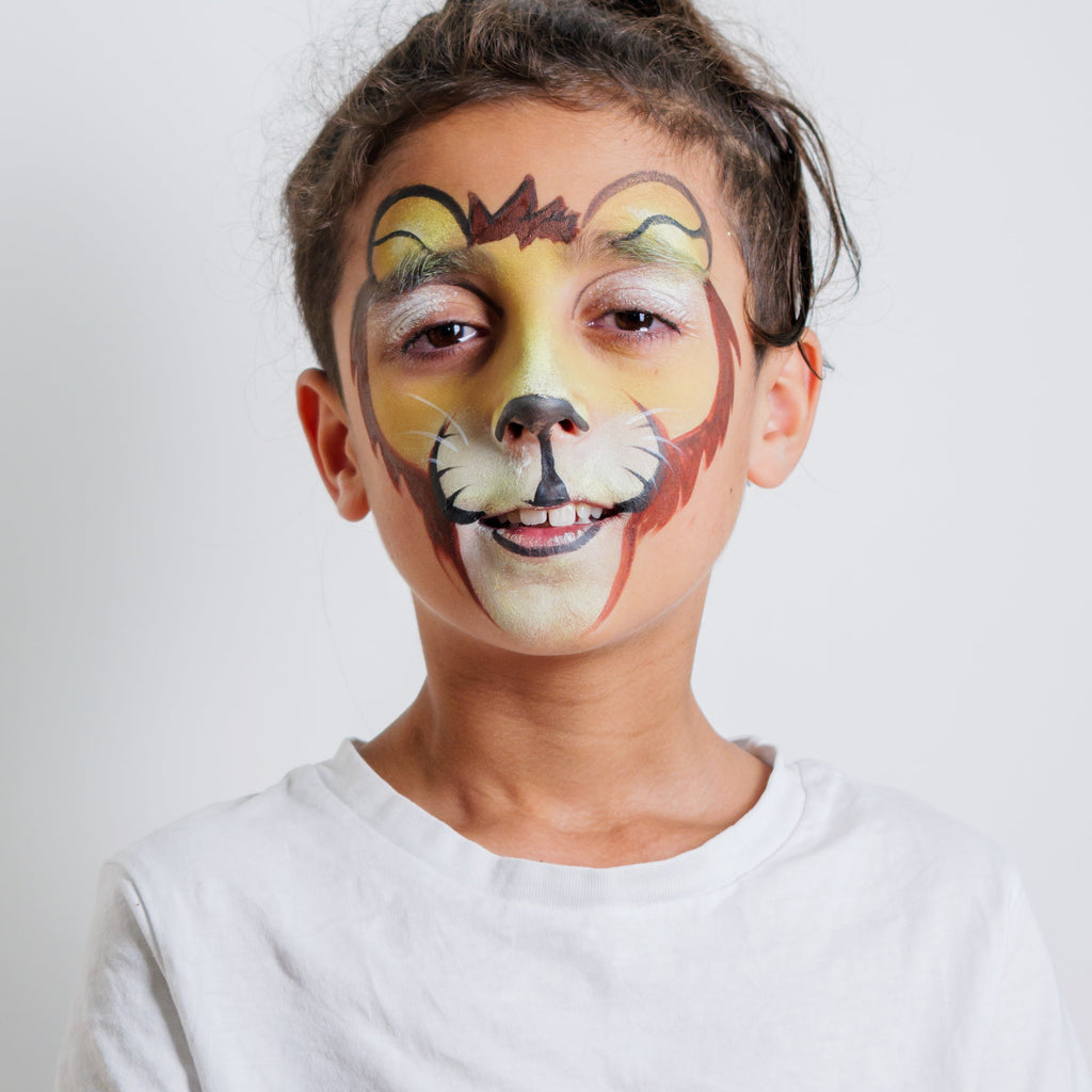 Child wearing a lion face paint design from the Animal Kingdom kit