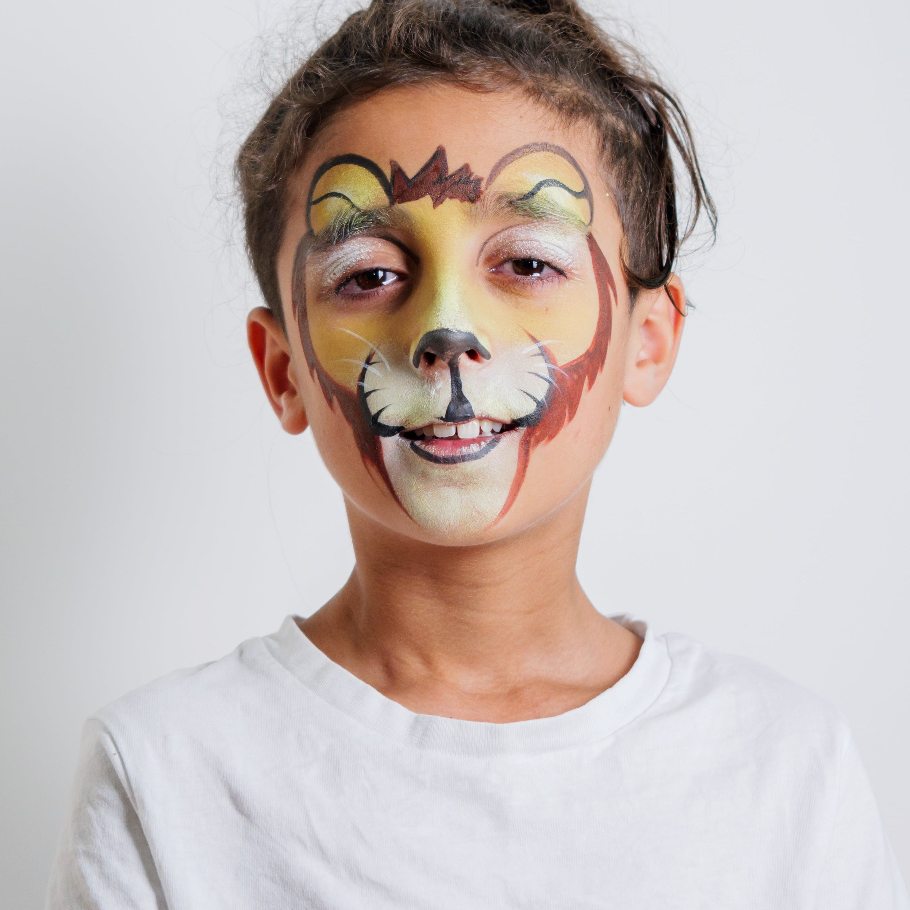 Child wearing a lion face paint design from the Animal Kingdom kit