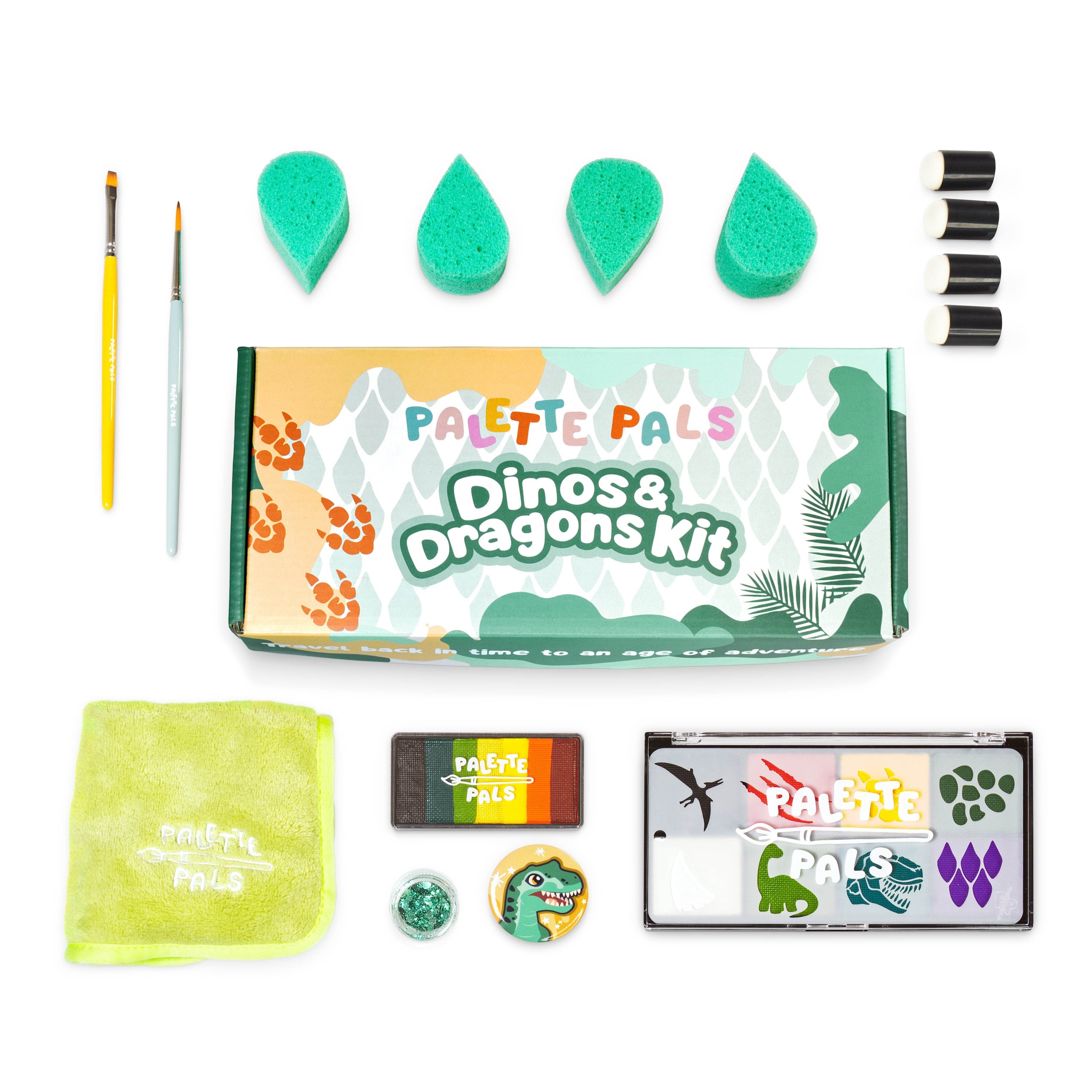Flat lay of the Dino & Dragon kit: face paint palette, brushes, sponges, reusable stencils and design cards