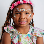 Child wearing a flower crown face paint design from the Garden Party kit
