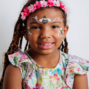 Child wearing a flower crown face paint design from the Garden Party kit
