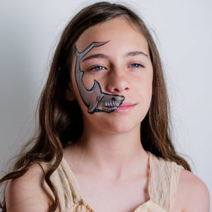 Child wearing a pirate face paint design from the Oceans Adventure kit