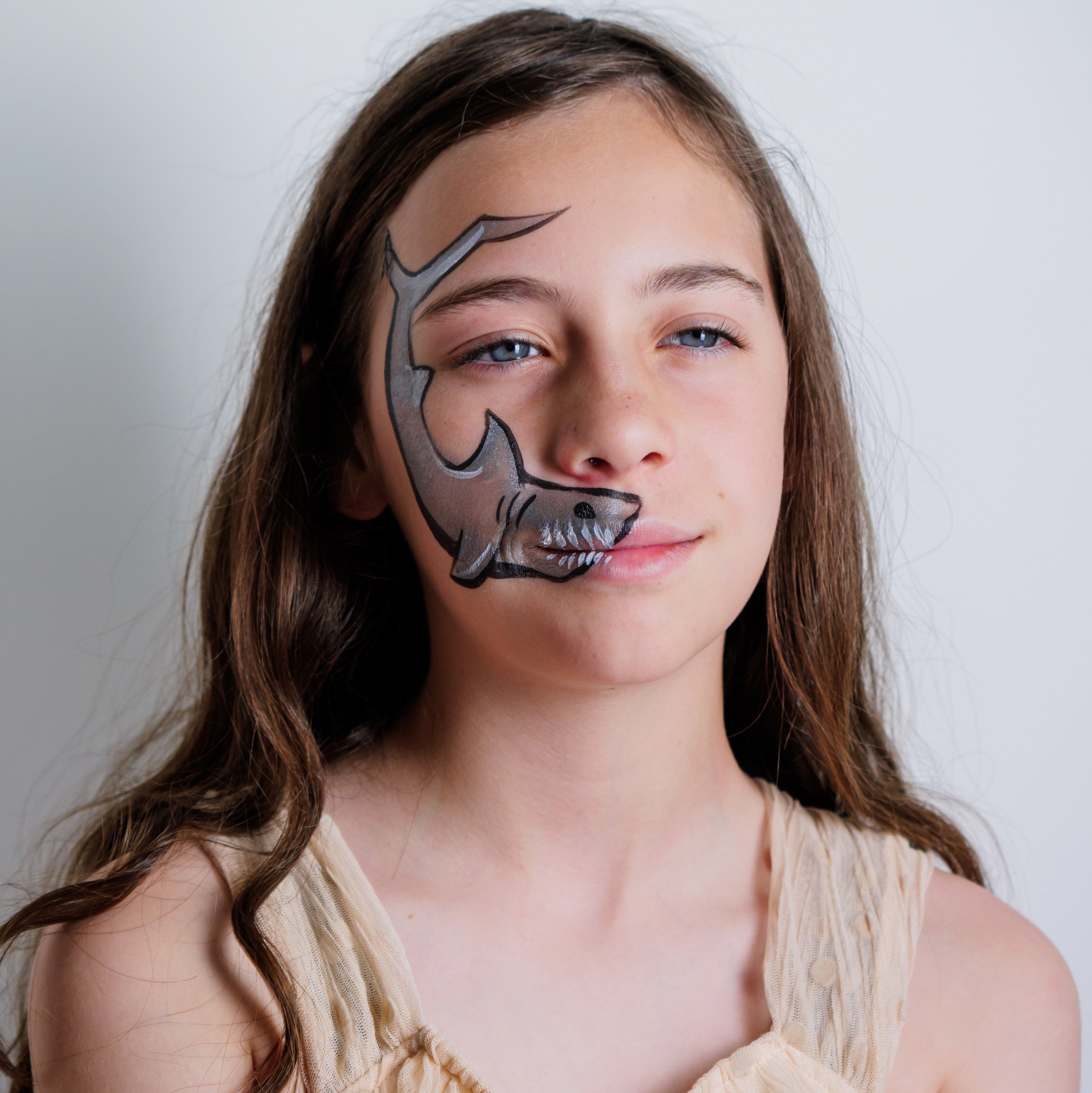 Child wearing a pirate face paint design from the Oceans Adventure kit