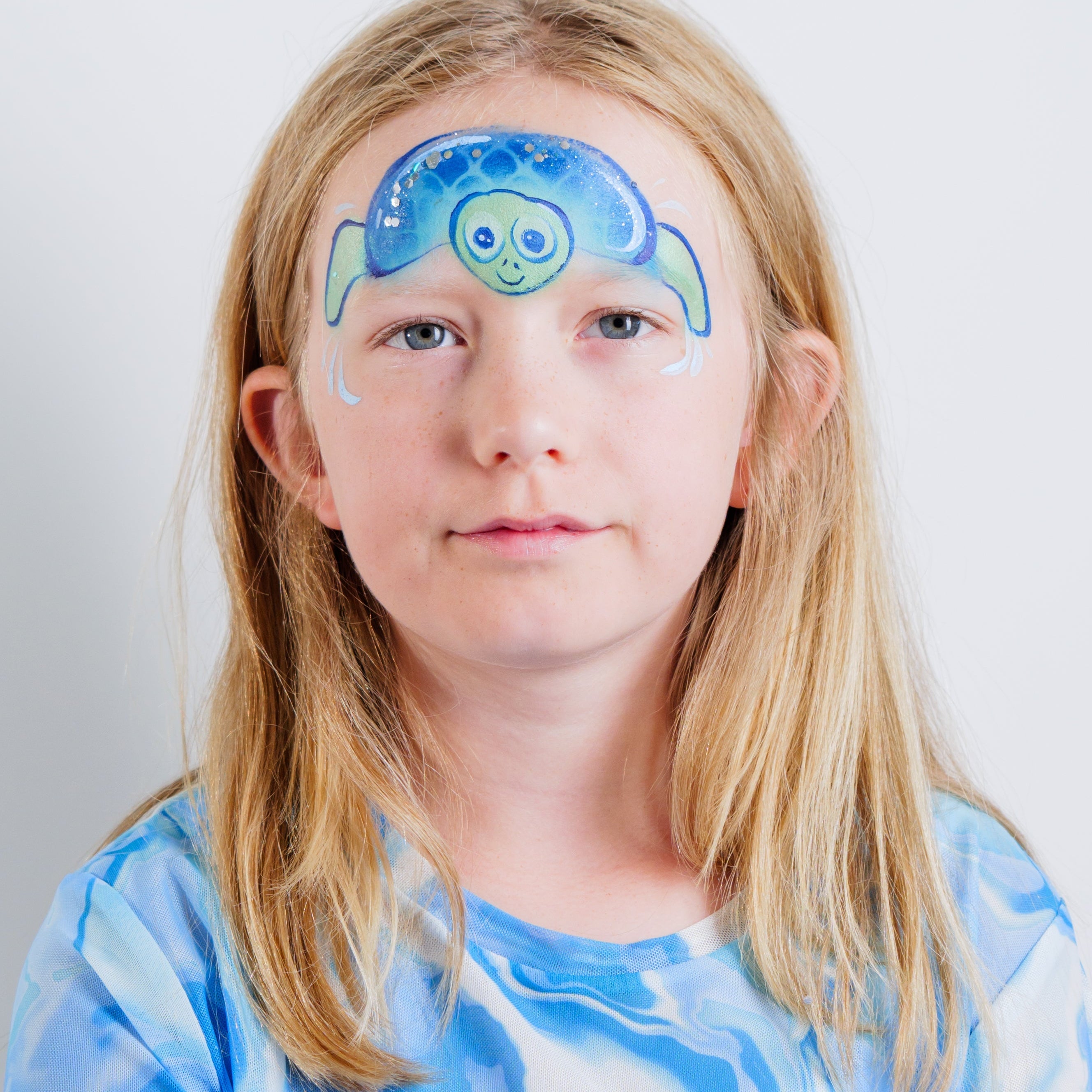 Child wearing a shark face paint design made with the Oceans Adventure kit