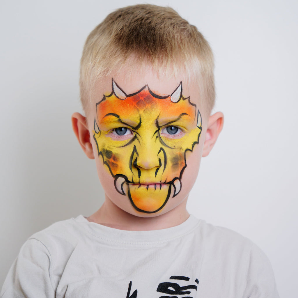 Child wearing a dragon face paint design from the Dino & Dragon kit