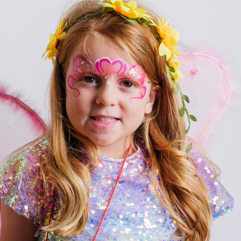 Parent painting a child's face at home using the Palette Pals FairyTales kit