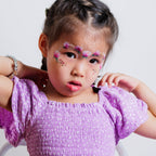 Child wearing a caterpillar face paint design from the Garden Party kit