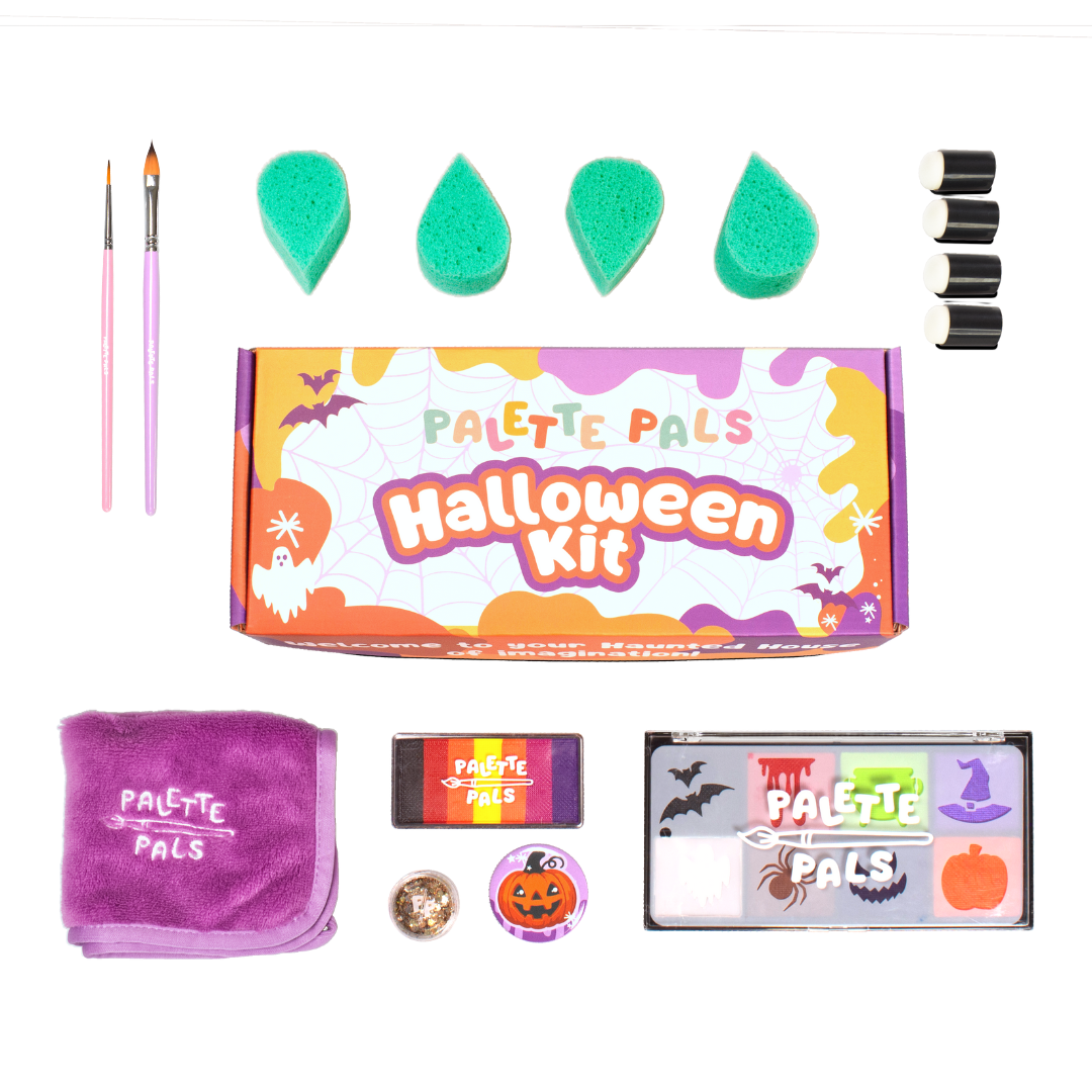 Flat lay of the Halloween kit: face paint palette, brushes, sponges, reusable stencils and design cards